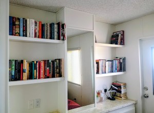 Image shows the author's bookshelves inside their park model home. This provides a visual confirmation on the limited space they have for storage.