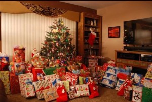 Shows writer's table-top Christmas trees and presents sitting around on the floor.